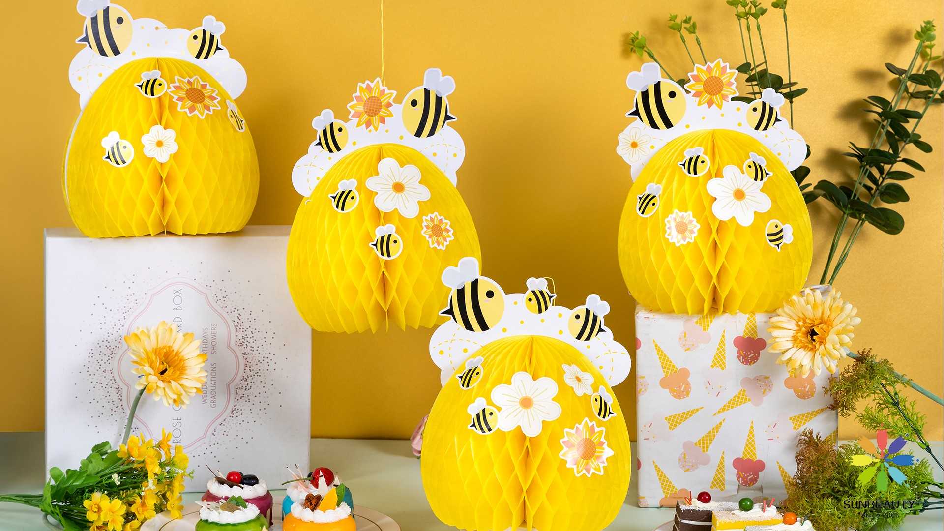 Bee-themed paper honeycomb decorations featuring intricate honeycomb structures with adorable bee motifs.