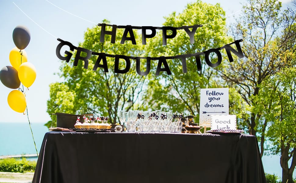 happy graduation banner with black and yellow balloon bouquets