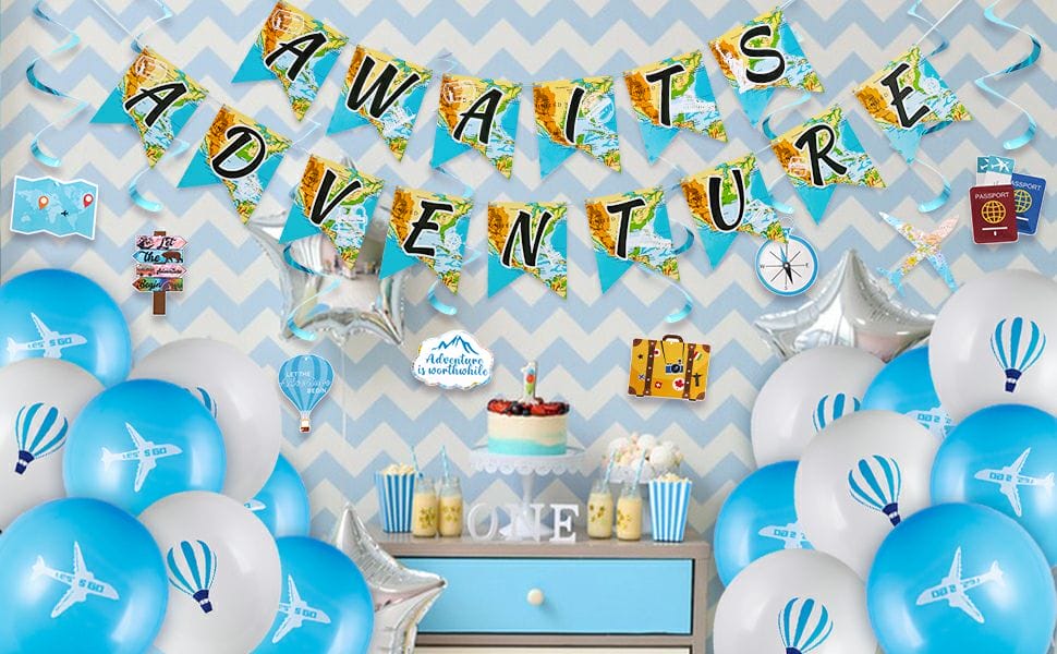 travel themed party decorations with banner, swirls and balloons