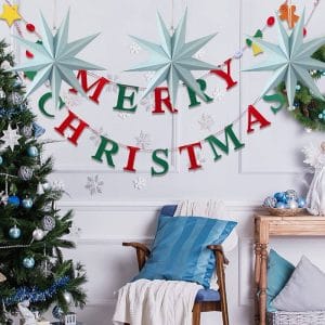 Christmas home decorations with merry christmas banner and blue paper stars