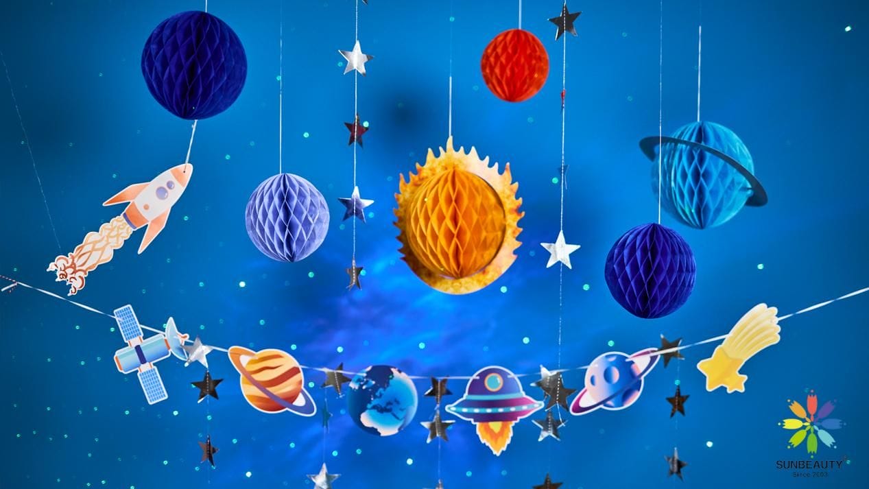 space themed party decorations with planet paper honecyomb and banner
