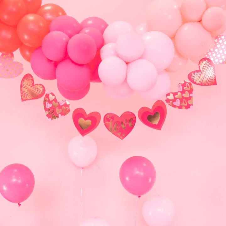 Pink Valentines Day Decorations with balloons and heart garland