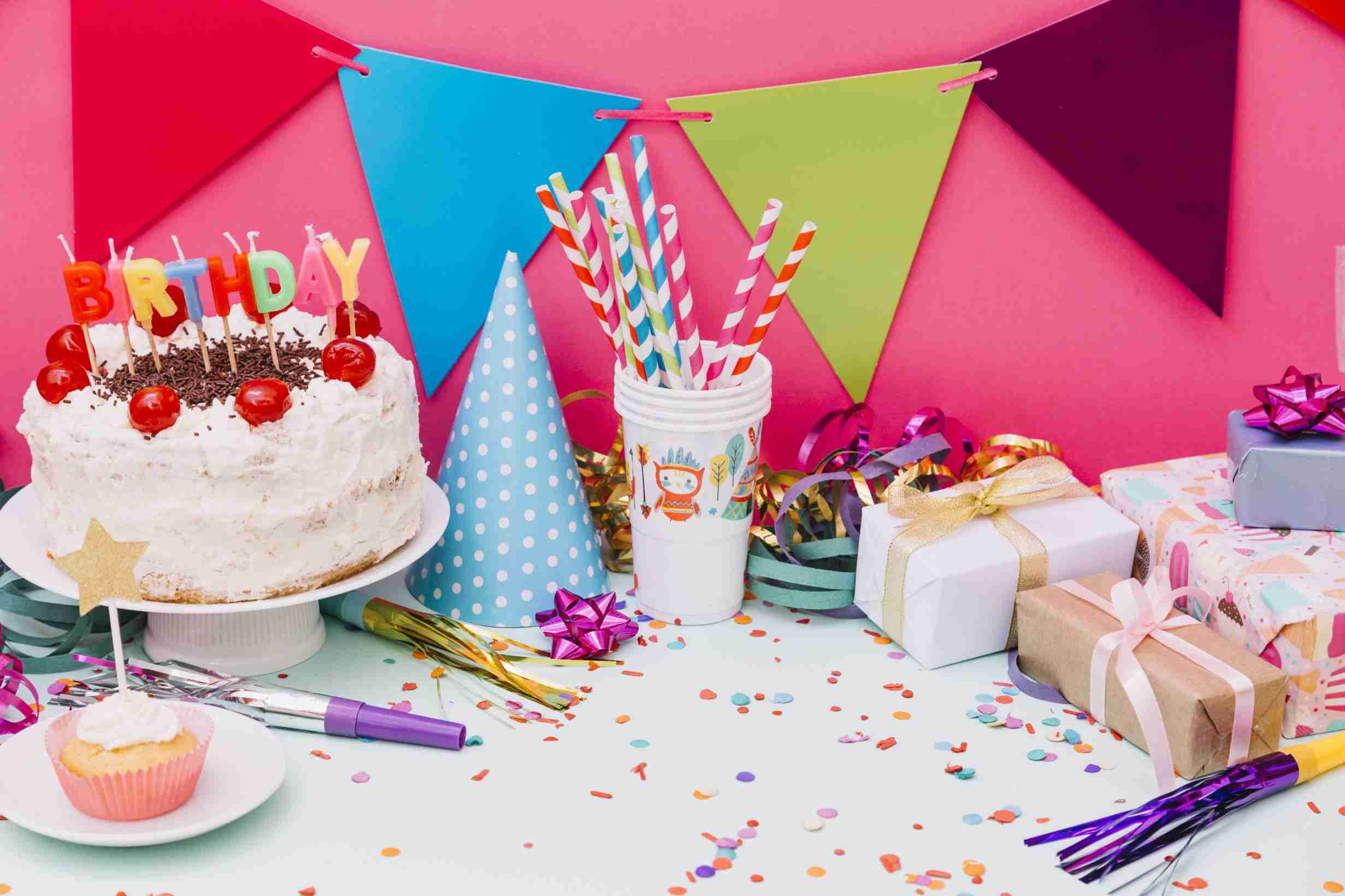 birthday cake with party accessories confetti blue background