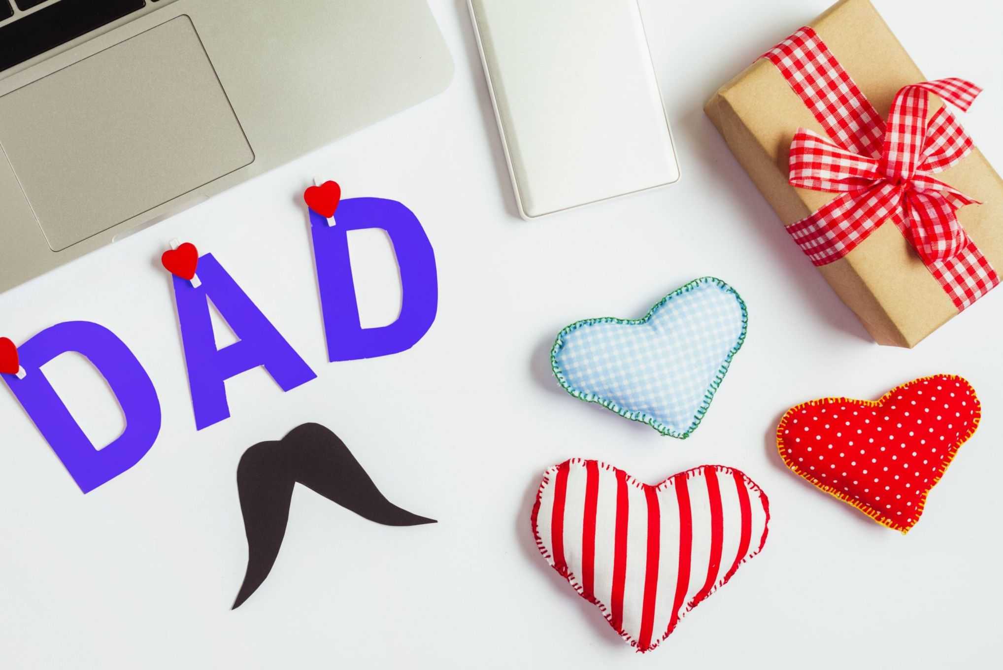 fathers day composition with laptop hearts