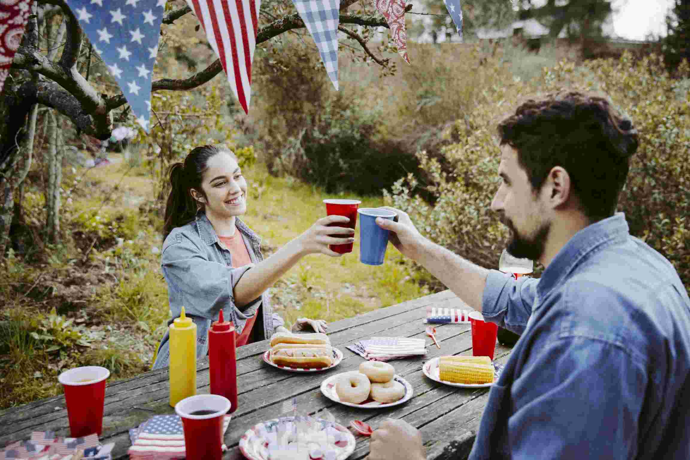 man woman clinking glasses independence day celebration