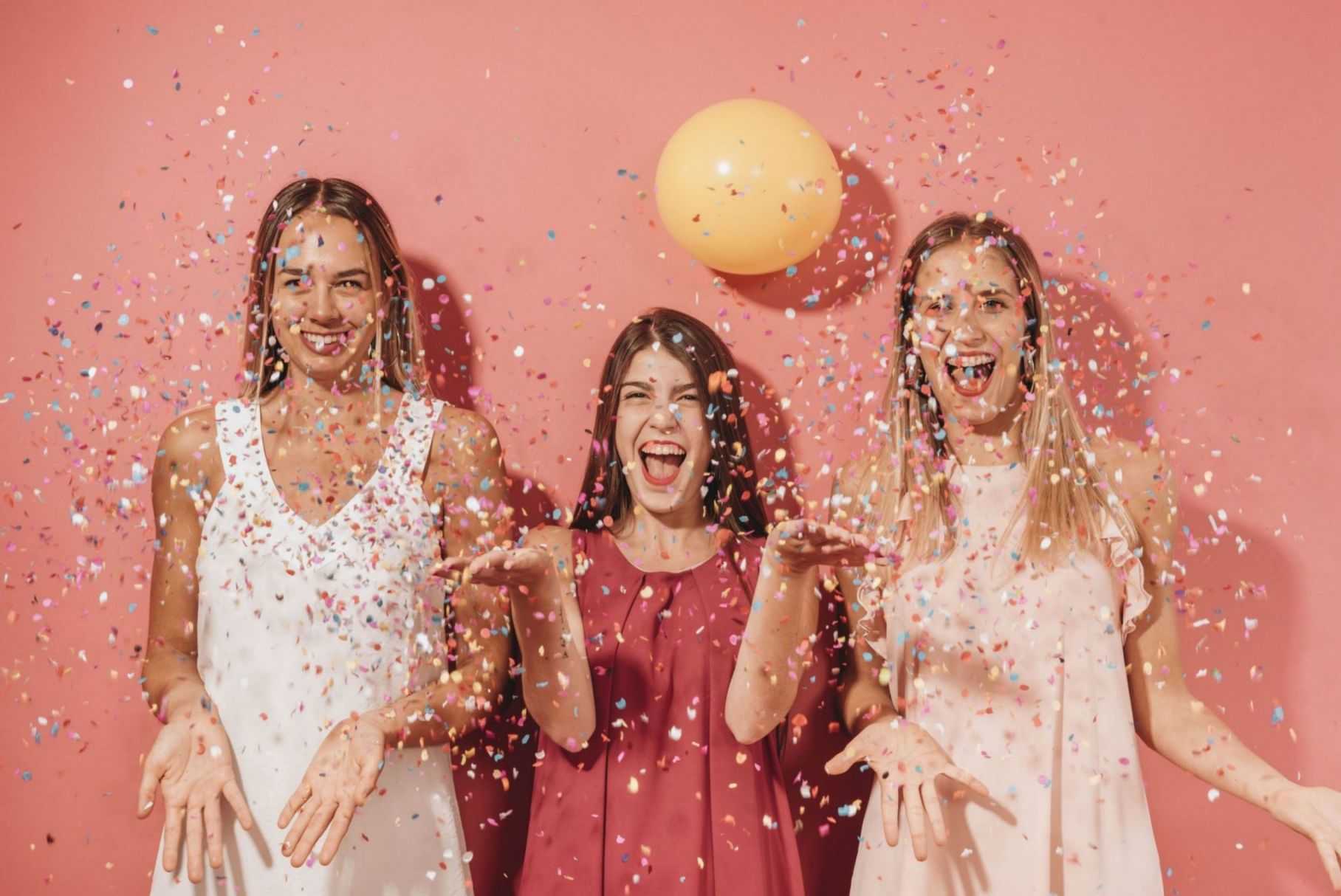 party friends posing with confetti