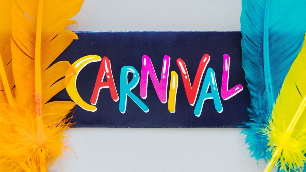 carnival writing with multicolored feathers