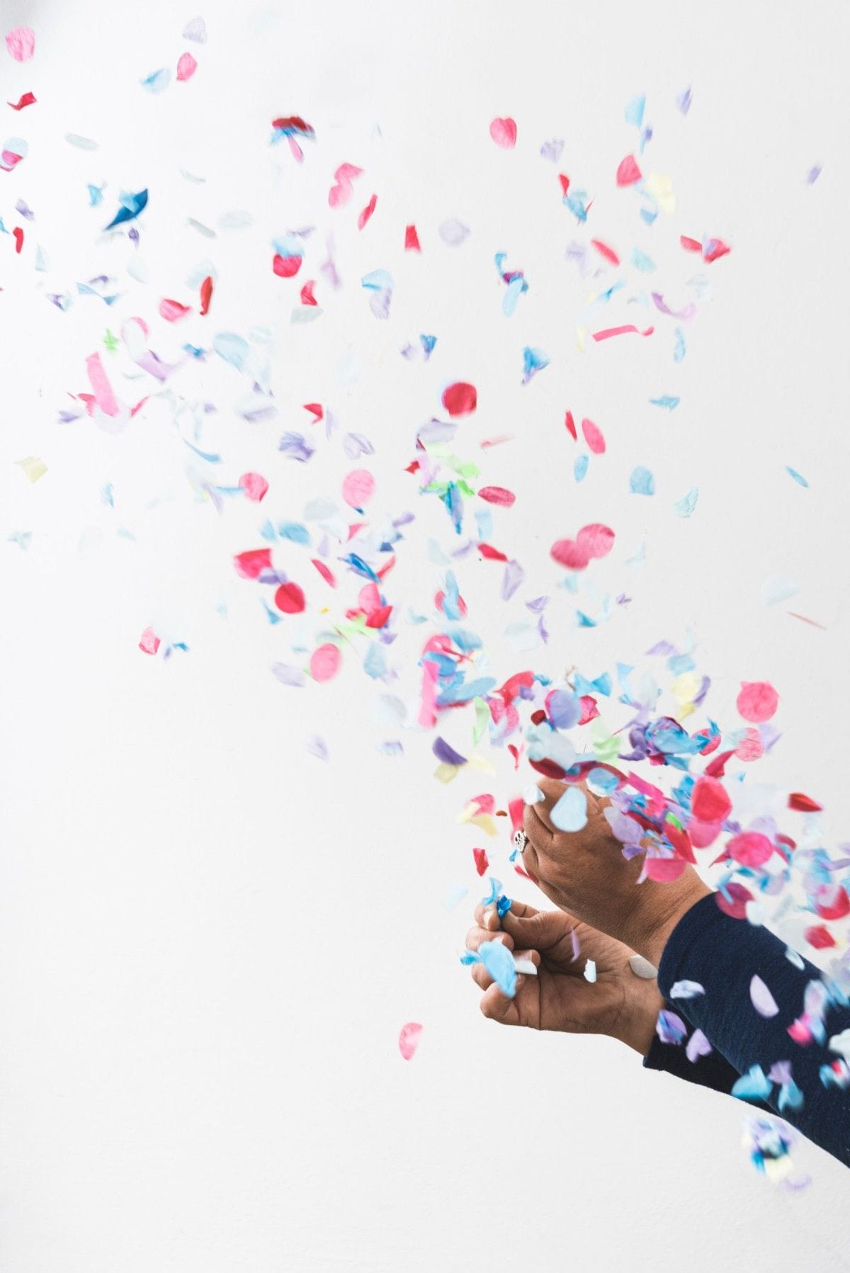 person hands colorful confetti popper