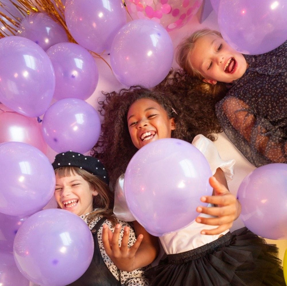 portrait young girls party with balloons decor