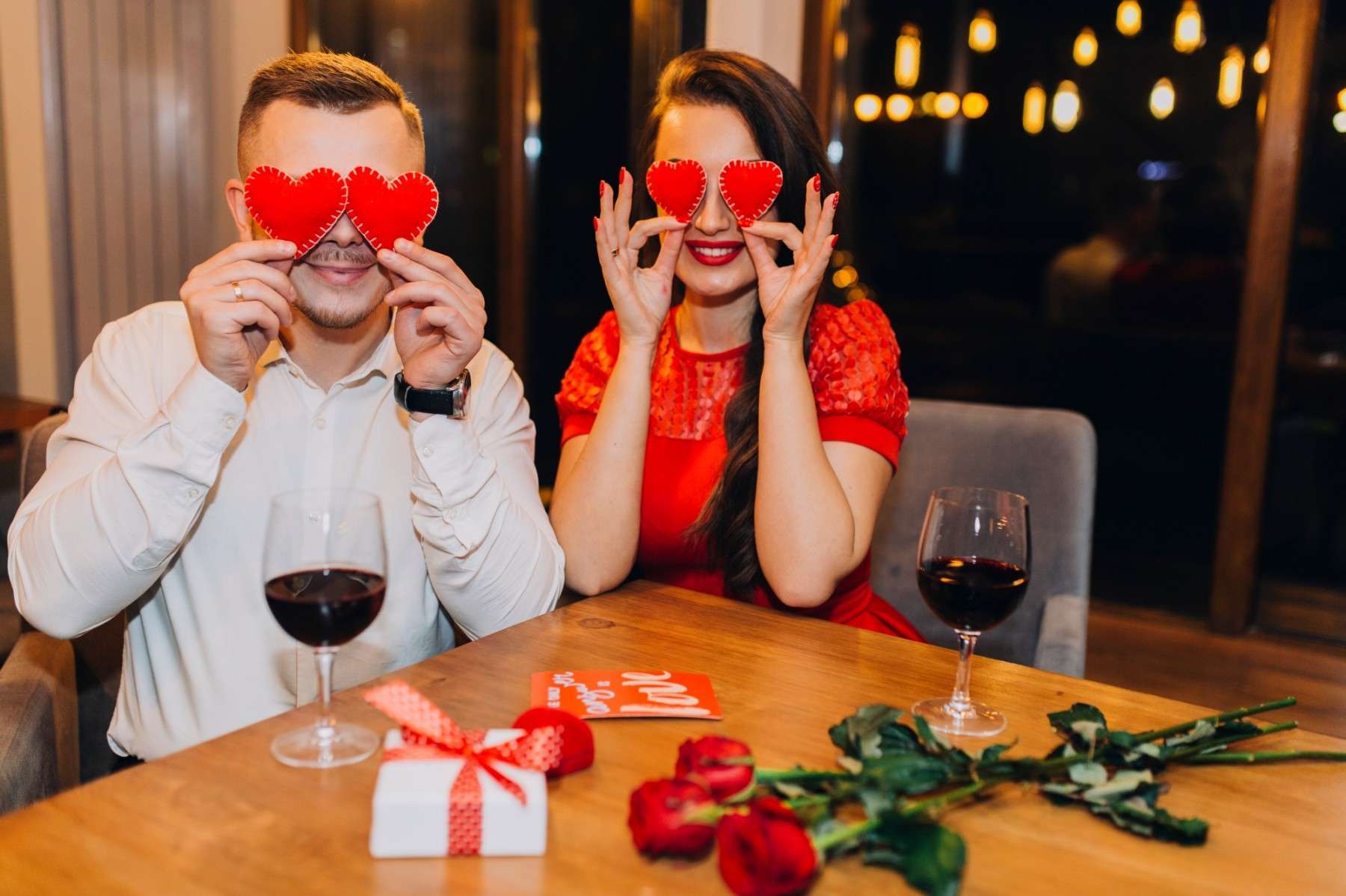 charming couple posing playfully cafe