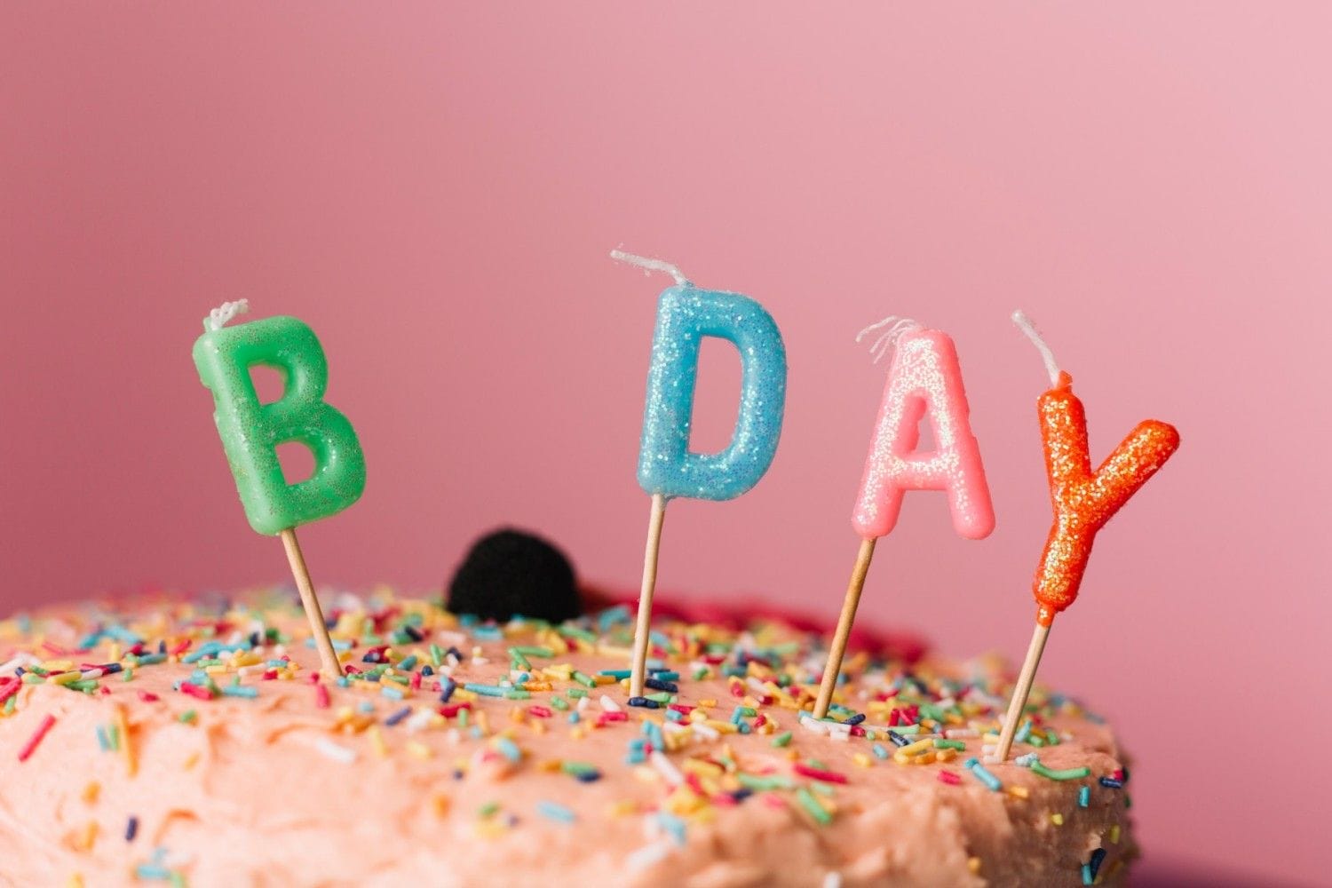 birthday candles cake against colored background