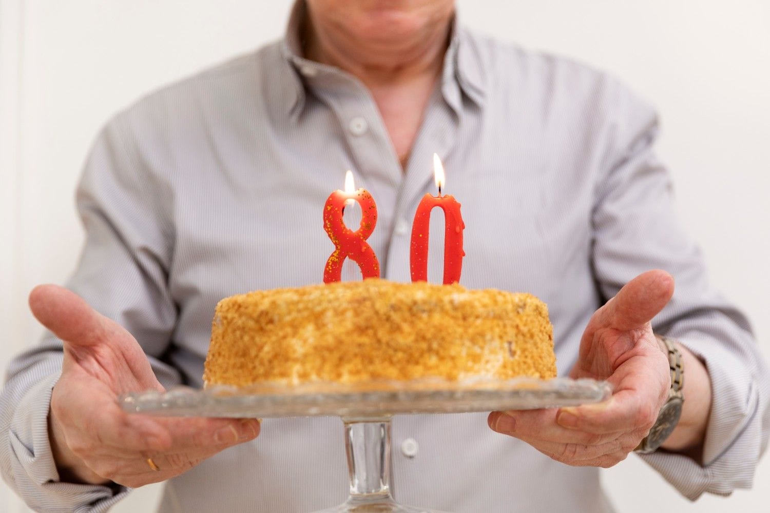 hands holding cake plate