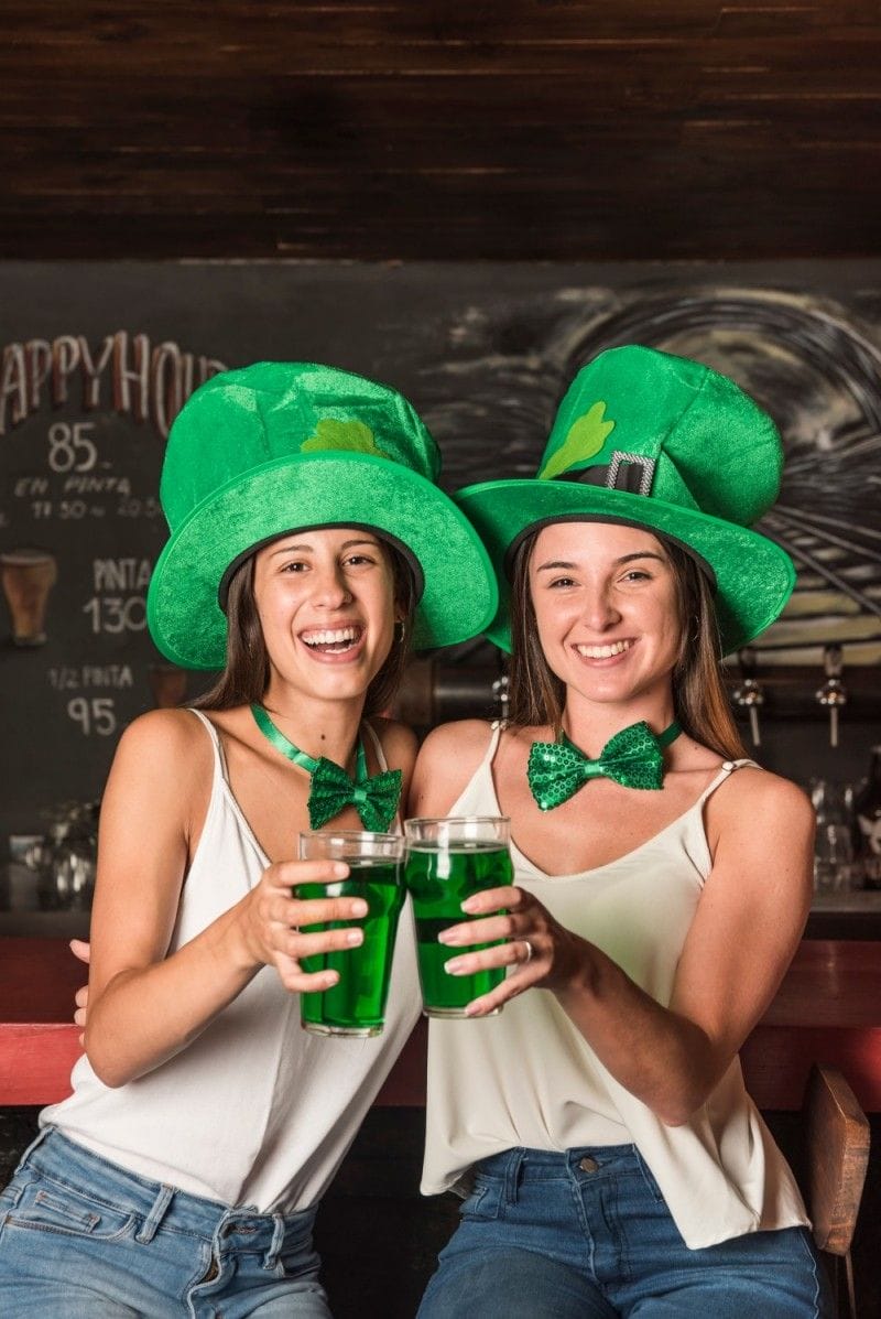 laughing young women saint patricks hats st patricks day