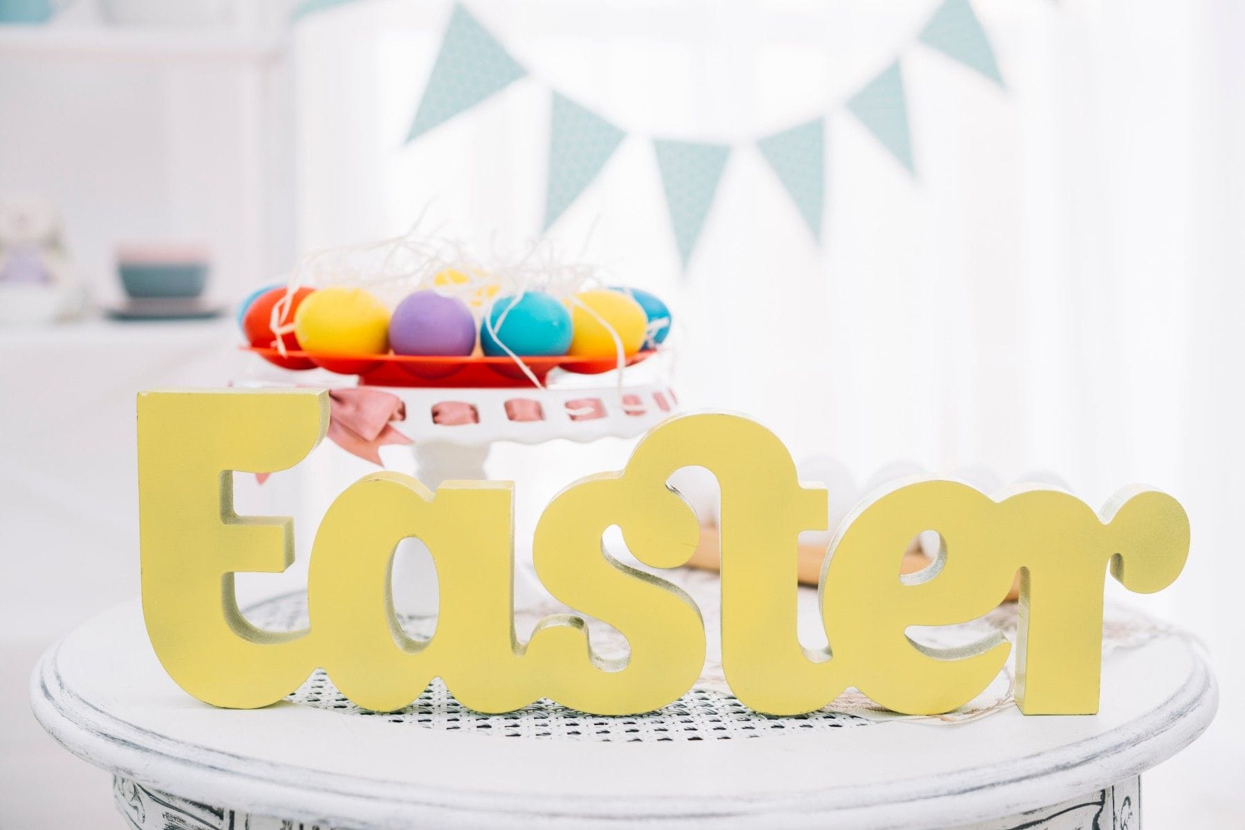 yellow easter text front colorful easter eggs cakestand