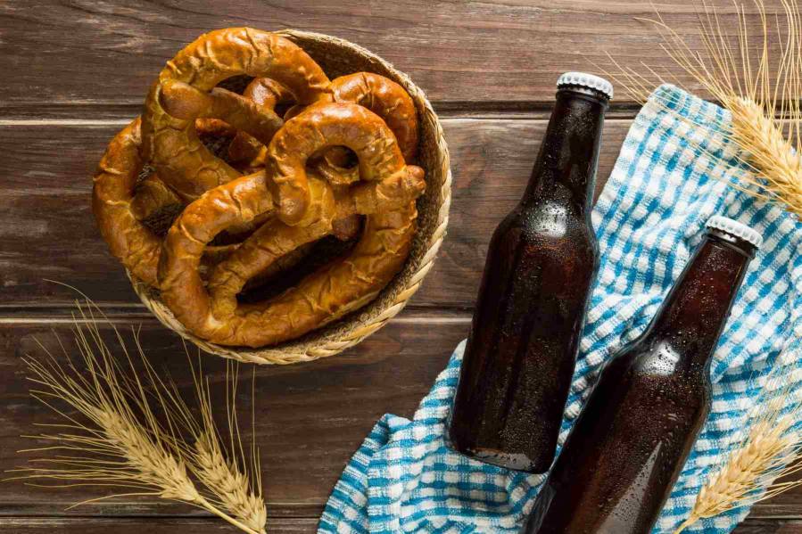 flat lay beer bottles with pretzels wheat
