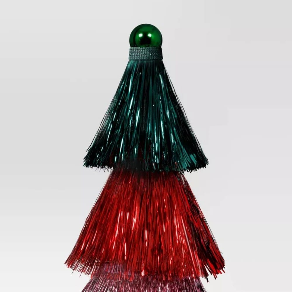 A tiered tinsel decoration with green colored top and red colored middle, topped with a green colored sphere.