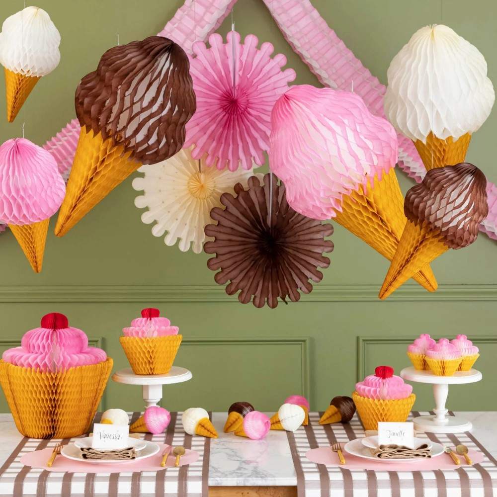 Honeycomb Celebration Fan Set of 3 strung on a wall styled above a sweet themed table setting.(1)