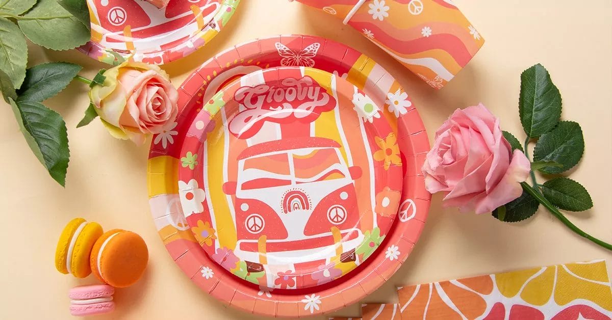 A colorful, 60s-inspired set featuring a red VW van, peace signs, and flowers, with matching plates, napkins, and cups.